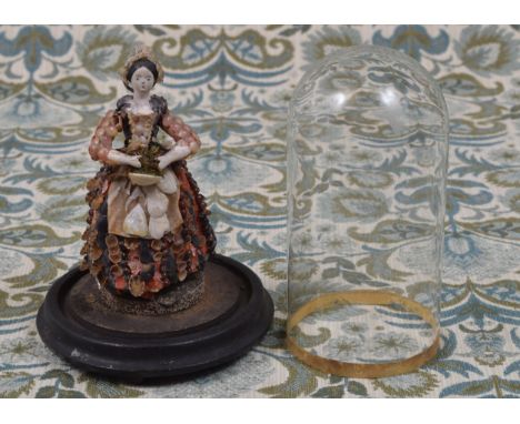 Folk Art, Maritime and Conchology Interest - an early to mid 19th century shell doll, the wooden shoulder head with painted f