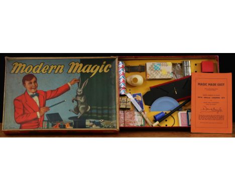 A mid 20th century Kay Modern Magic conjuring set, comprising an assortment of magic tricks and novelties, boxed with literat