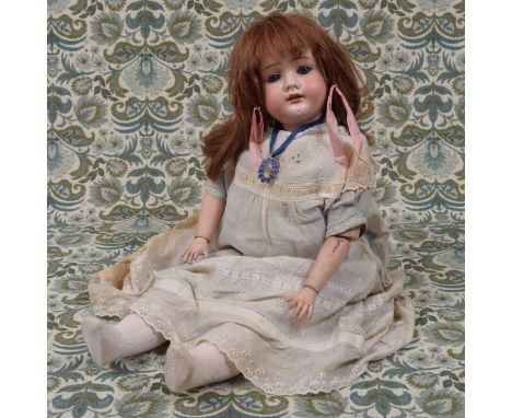 A German bisque head and painted ball jointed composition bodied doll, the bisque head with weighted sleeping blue glass eyes