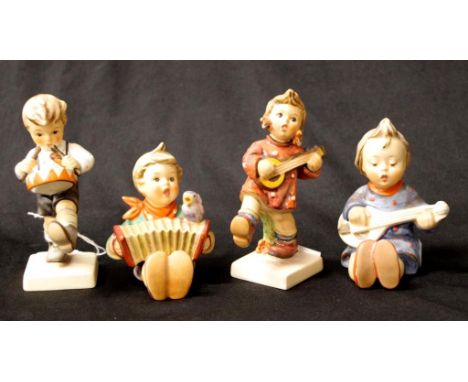 Four various Goebel Hummel figurines including Boy playing a drum, 10.5cm high (tallest) approx.