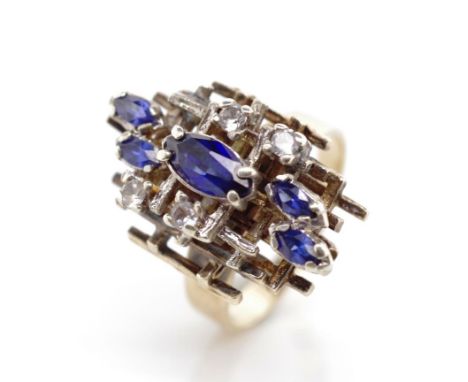 Sapphire set 9ct yellow gold Brutalism ring set with blue sapphires and spinels. Marked 9ct. Approx weight 6.7 grams, ring si