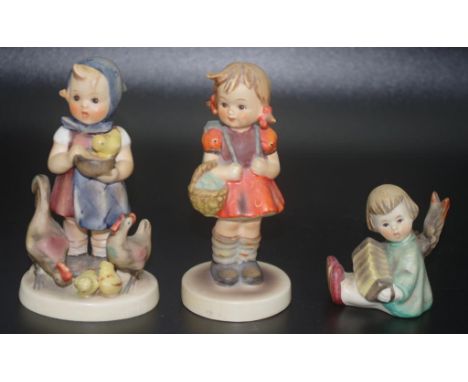 Three Goebel Hummel figurines including "Feeding Time", 6cm - 11.5cm high approx