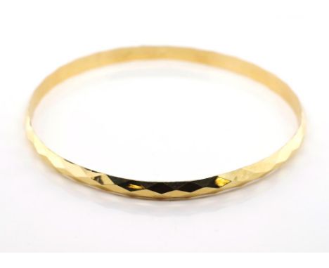14ct yellow gold faceted bangle marked K14. Approx weight 7.27 grams, inside width 68mm