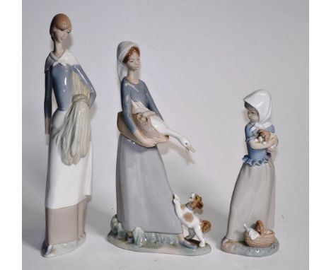 Lladro girl holding a duck figurine 27cm high approx. and 2 Nao figurines (larger Nao figure as inspected)