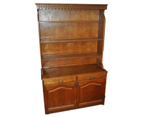 An oak dresser with three shelf top over a two door cupboard and two drawers, 190cm high