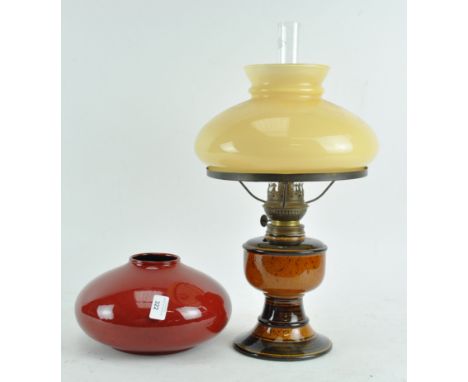 A West German pottery oil lamp marked beneath " Atellier Renee Hand Gemacht and a red glazed shallow round vase