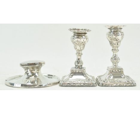 A pair of silver candlesticks, 12cm high and a silver inkwell