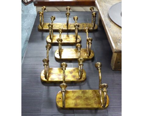 COAT HOOKS, a set of five, one large and four small in bronzed metal finish, 46cm and 23cm L. (5)
