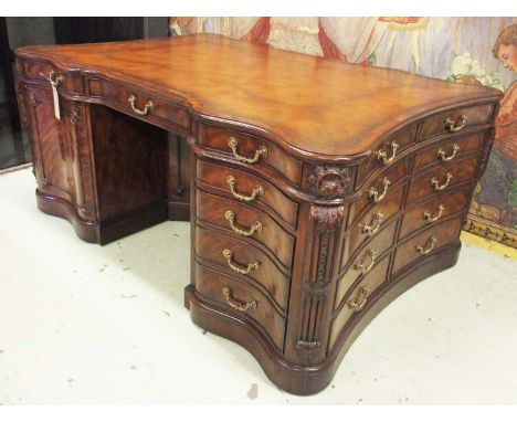 PARTNERS DESK, By Brights of Nettlebed, Chippendale style mahogany with a shaped tan leather top over twelve drawers and two 