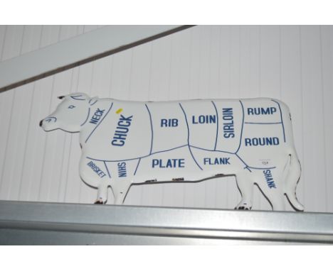 An enamel cow sign