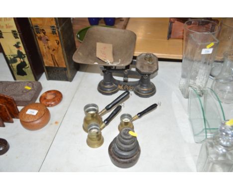 A set of scales and weights together with three brass measures