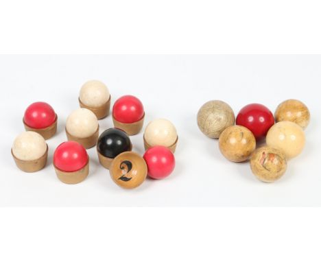 Fifteen assorted Victorian ivory turned billiard balls, including stained examples and a set of nine held in turned wooden cu