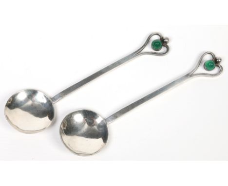 A pair of Arts & Crafts silver spoons by Albert Edward Bonner. With openwork heart shaped terminals set with jade coloured st