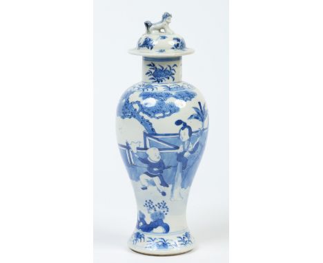 A 19th century Chinese baluster vase and cover. Painted in underglaze blue with figures in a garden landscape. Four character