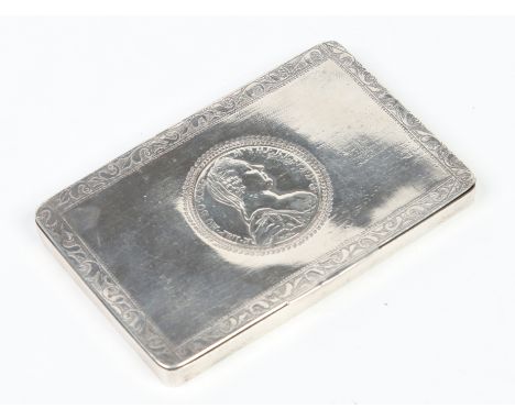 An early 19th century Continental white metal table snuff box with engraved banding and set with a silver Thaler, 12cm wide. 