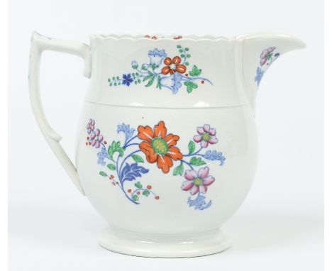 A Don pottery jug with lobed rim and scrolling handle. Printed in underglaze blue and enamelled with bouquets and flower spra