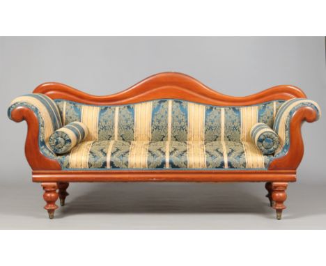 A Victorian camel back mahogany scroll arm settee, raised on turned baluster supports and with new silk upholstery, 196 cm wi