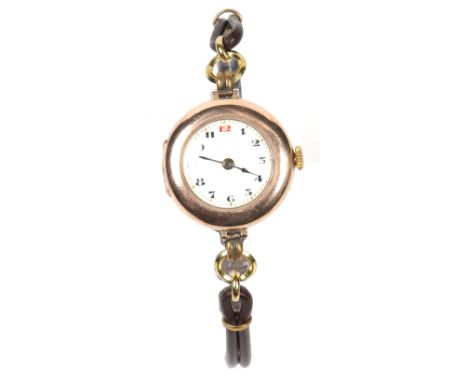 An early 20th century Rolex 9 carat gold cased manual wristwatch. With enamel dial having Arabic numeral markers, 2.5cm wide.