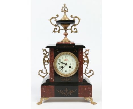 A 19th century French slate and rouge marble mantel clock with gilt metal mounts. Surmounted with a large twin handled urn sh