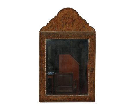 A Queen Anne style wall mirror with arched pediment and beadwork frame decorated with flowers, having giltwood mouldings and 