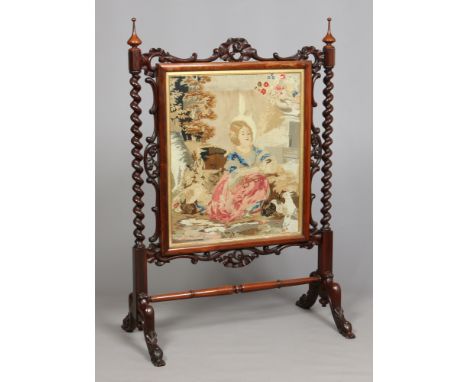 A Victorian carved rosewood firescreen of Country House proportions. Set with a woolwork tapestry depicting a young girl and 