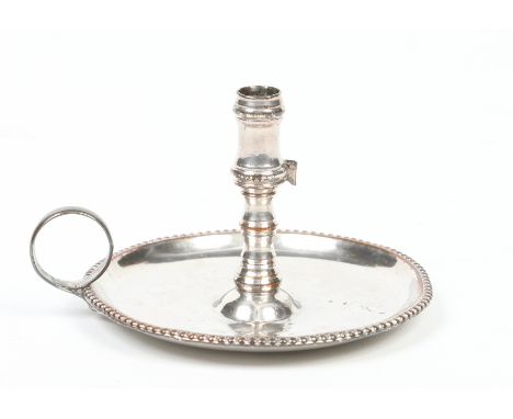 An Old Sheffield plate taper stick. With beaded rim and plain loop handle, 9cm diameter. Condition Report. To be used as a gu