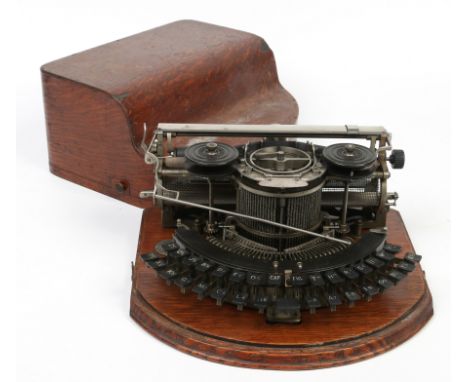 A vintage typewriter in oak case by the Hammond Typewriter co. New York.  Condition Report. To be used as a guide only. Some 