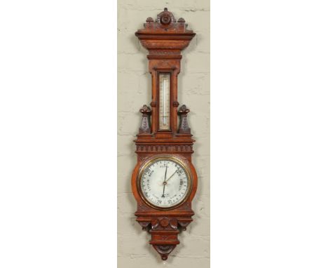 A Victorian carved oak banjo wall barometer by Gardiner & Co. With silvered dial and incorporating a thermometer, 103cm.