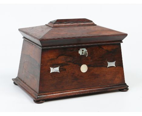 A Regency rosewood tea caddy of sarcophagus form. With mother of pearl inlay and raised on squat bun feet, 28cm wide. Conditi