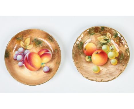 Two small Royal Worcester dishes. With gilt rims and painted with fruit, signed indistinct. Printed black mark. Largest 11.25