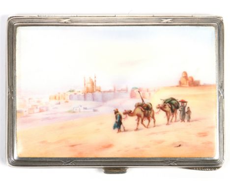 A Continental silver cigarette case. Enamelled to the cover with a desert scene incorporating camels, riders and with palatia