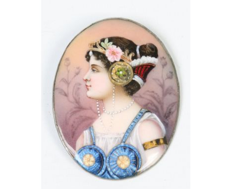 A 1920s Continental oval enamel portrait plaque of a young maiden in Grecian attire, 8cm
