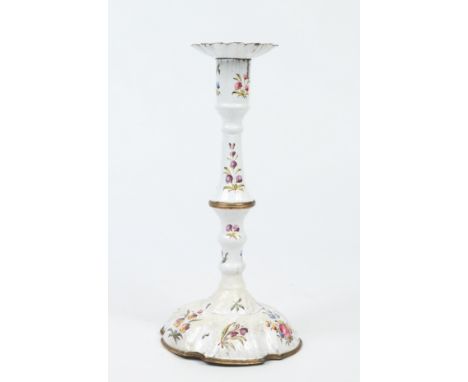 An 18th century Bilston enamel candlestick. With detachable nozzle and painted with flower sprays and scattered sprigs, 25cm.