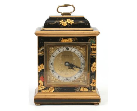 An early 20th century mantel clock by Elliot of London. In lacquered chinoiserie case and raised on brass squat bun feet, 22.