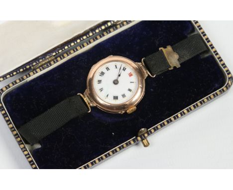 An antique 9 carat gold cased wristwatch. With enamel dial having Roman numeral markers, 26mm wide. Condition Report. To be u