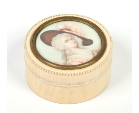 A 19th century turned and carved ivory snuff box with a painted circular portrait miniature to the top under a brass bezel,si