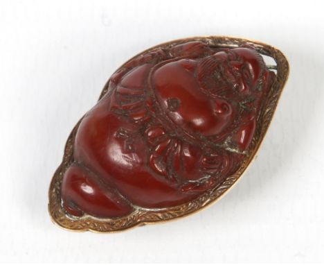 A Japanese Meiji period carved hardstone netsuke in yellow metal mount. Formed as a Buddha emerging from a conche shell, 3.5c