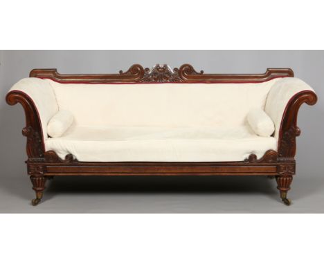 A Victorian carved rosewood settee with swan neck pediment, scroll arms and raised on reeded bun feet, 220cm wide. Condition 