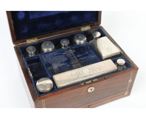 A Victorian rosewood fitted travelling vanity box inlaid with mother of pearl containing cut glass jars and bottles with silv