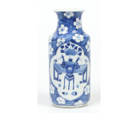 A 19th century Chinese sleeve vase. Painted in underglaze blue with a cracked ice ground bearing flower heads and with shaped