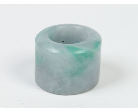 A Chinese lavender jade archers ring with apple green suffusions. Condition Report. To be used as a guide only. Good conditio