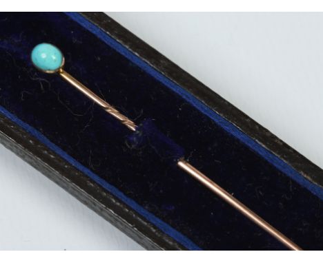 A cased yellow metal tie pin set with a cabochon turquoise stone.  Condition Report. To be used as a guide only. Good conditi