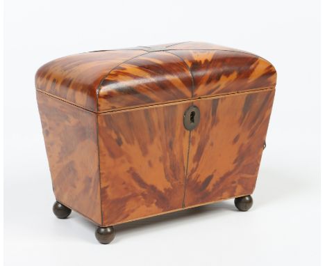 An early Victorian tortoiseshell tea caddy. With strung inlay, two lidded compartments and raised on four ball feet, 18cm wid