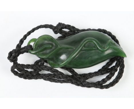 A carved spinach jade pendant modelled in the form of a stylized flower, 8cm. Condition Report. To be used as a guide only. N