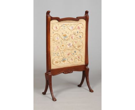 An Edwardian mahogany firescreen set with a silk needlework panel, 89cm.