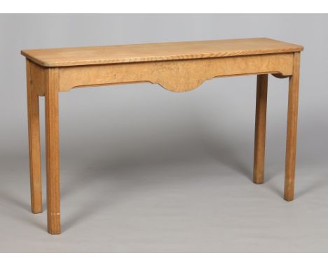 Manner of Sir Robert Lorimer. An Arts & Crafts light oak and burr wood side table with two piece top raised on square reeded 