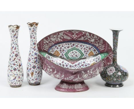Five pieces of Persian enamel ware. Including an oval bowl on stand decorated with topographical panels over a floral ground,