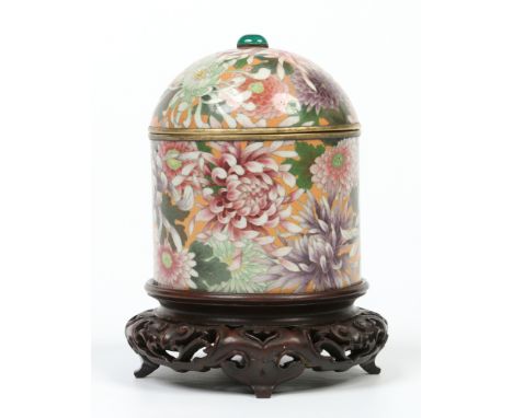 A Japanese Meiji period cloisonne jar with domed cover and raised on a carved hardwood plinth. With spinach jade finial and d