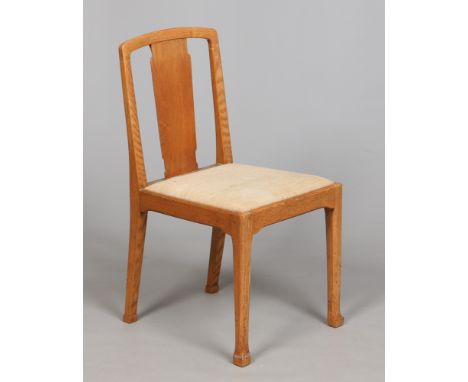 An Arts & Crafts light oak side chair. With flat stylized baluster splat and raised on chamfered tapering square supports. Co