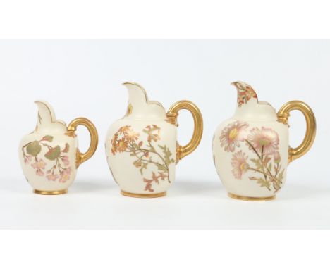 Three Victorian Royal Worcester flat back jugs with reeded loop handles. Ground in old ivory and decorated with flowers. Prin